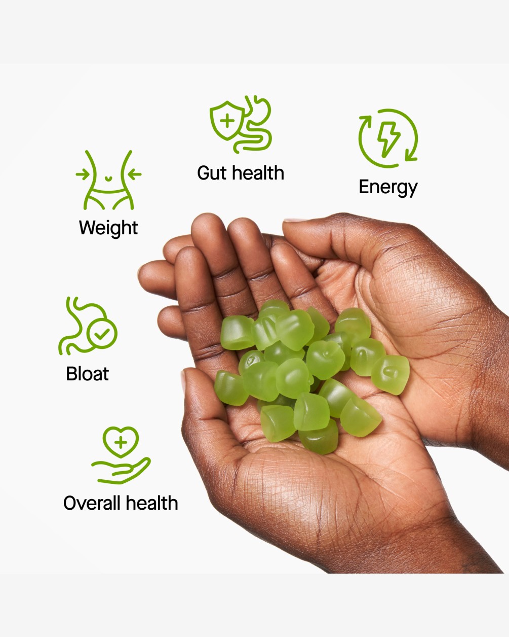 A close-up of a person's cupped hands holding a pile of green SpoiledChild J29 gummy supplements. Surrounding the hands are green icons and text for health benefits: Weight, Gut health, Energy, Bloat, and Overall health.