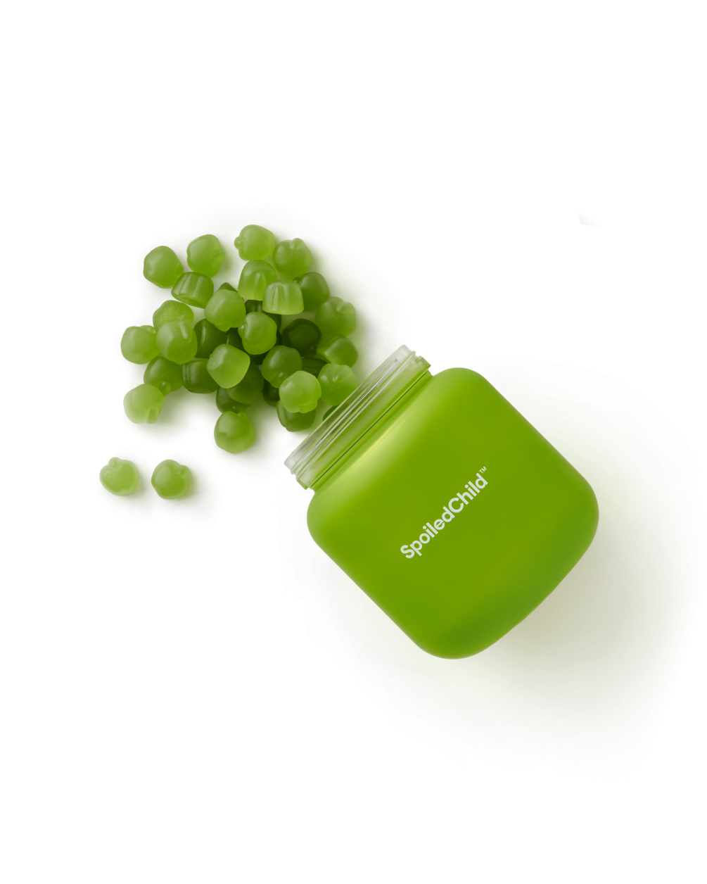 A green, square SpoiledChild J29 jar tilted on its side with small, round green gummy supplements spilling out onto a white surface.