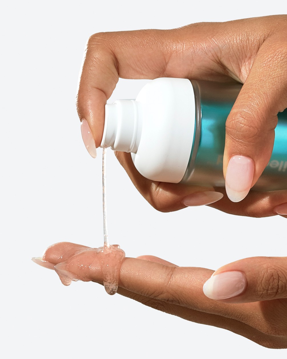 A person with a pale pink manicure dispenses a clear, gel-like liquid from a SpoiledChild S33 pump bottle onto their fingertips.